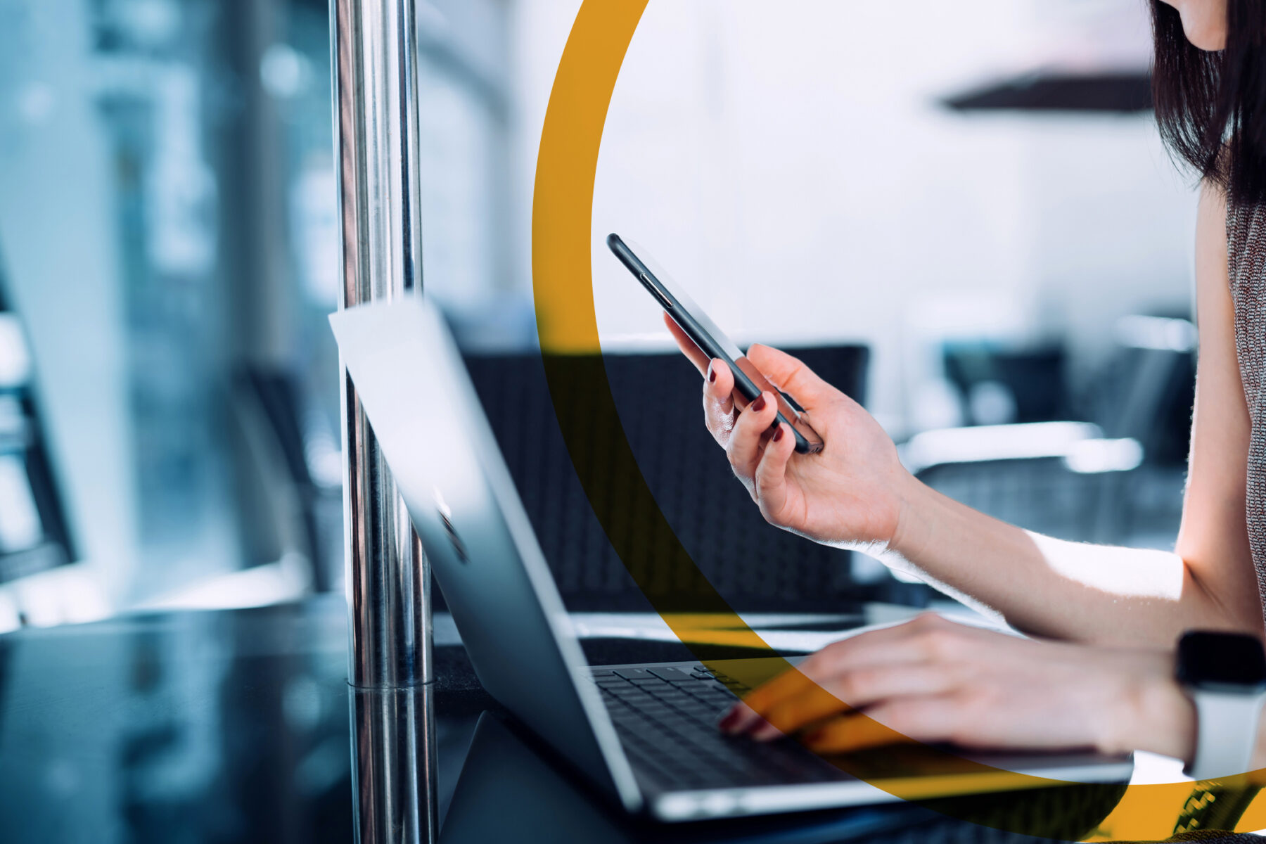 woman using a mobile phone and a laptop