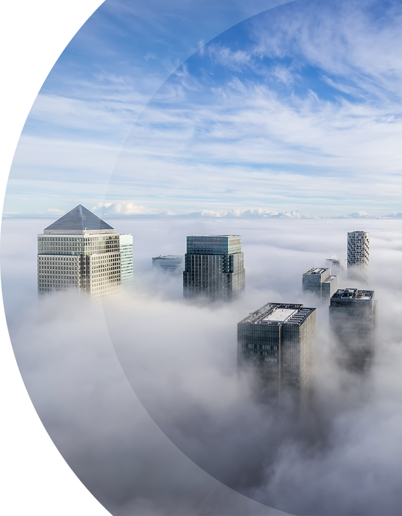 a curved image featuring skyscrapers peeking above the clouds